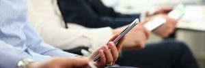 people's hands holding phones for viewing