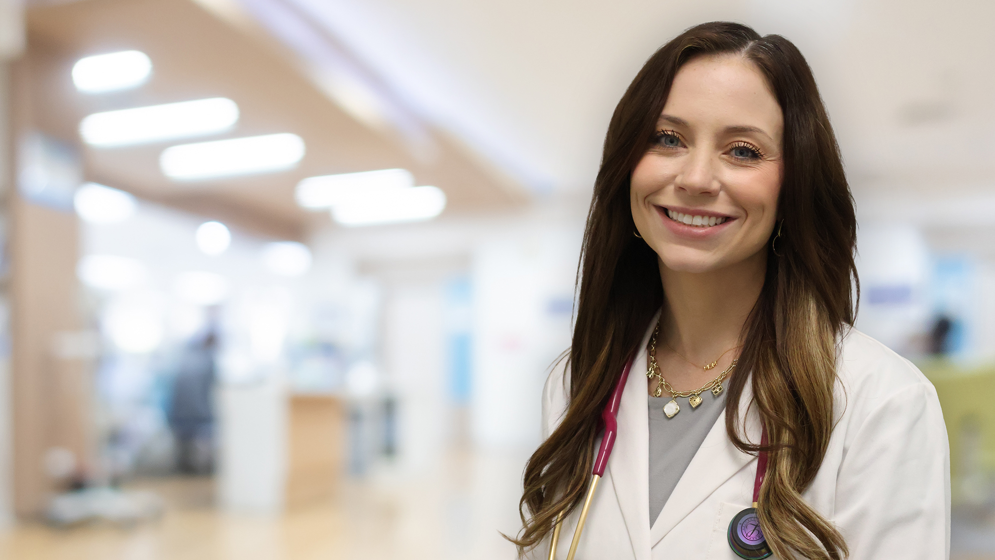 Ashley Haasis professional headshot on blurred lobby background