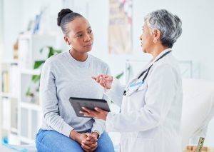 Female physician providing health information to a female patient.